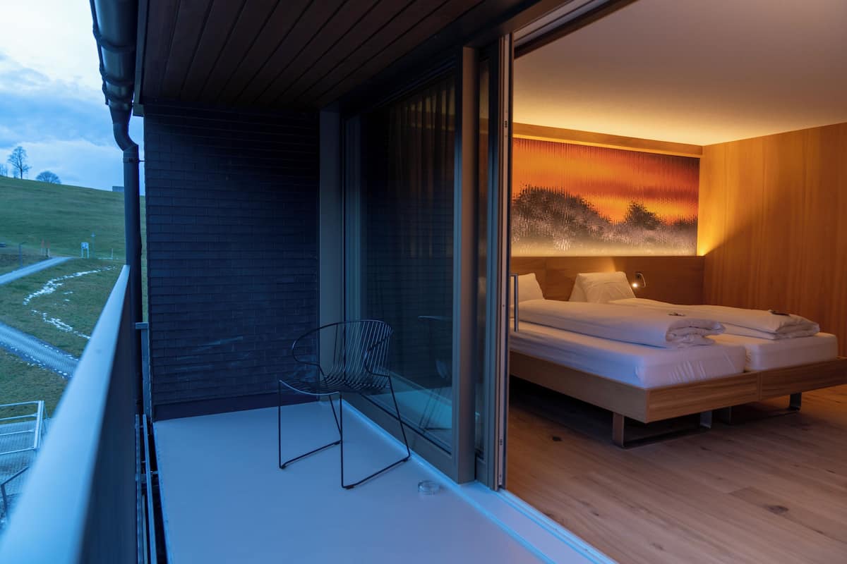 deluxe quadruple room, mountain view | living area | flat-screen tv