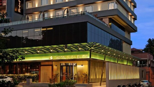 A multi-story hotel with a modern design, featuring a prominent entrance with a glass canopy and a sign reading "HOTEL SUBAELITE". - Hotel Suba Elite Vadodara (Vadodara)