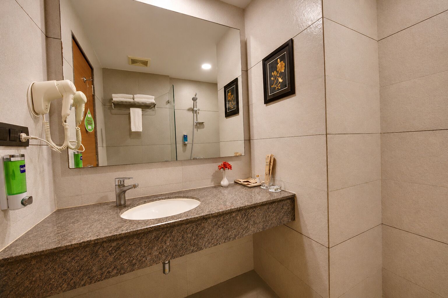 A bathroom with a sink, mirror, towel rack, and a hairdryer.