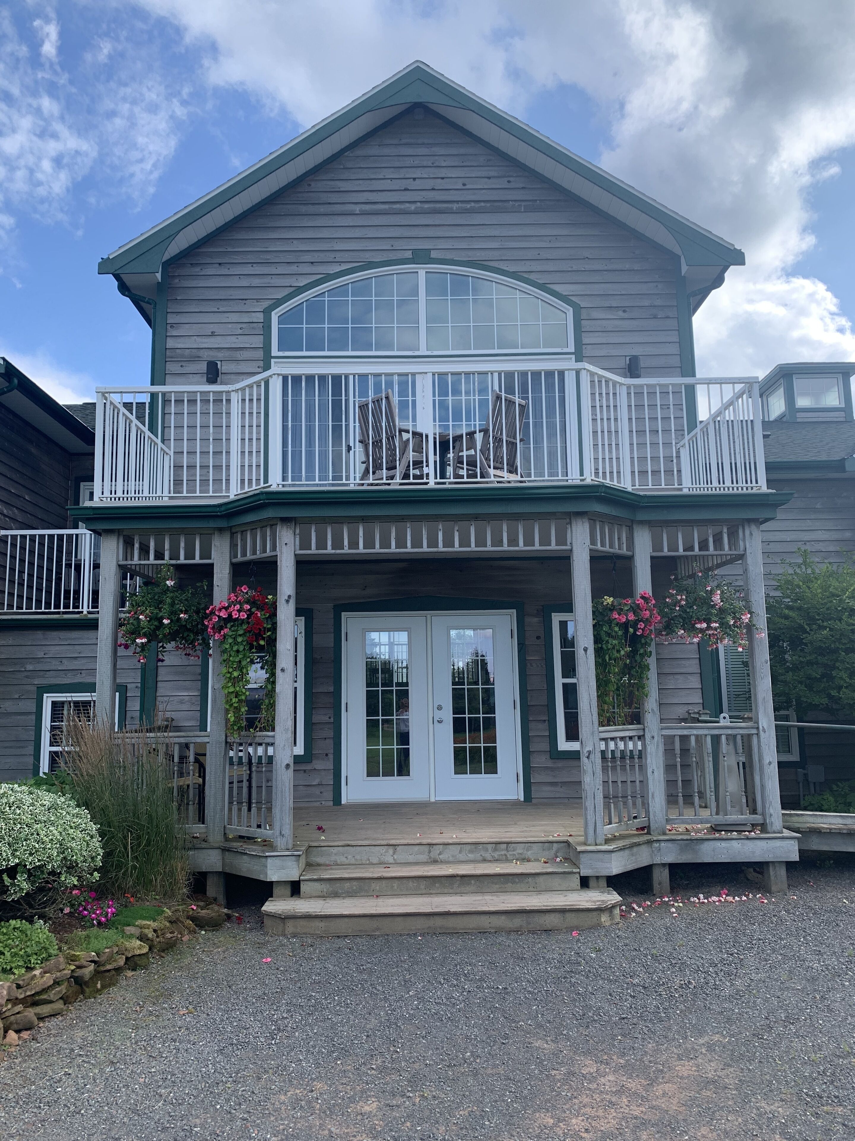 A two-story house with a balcony, a front porch, and a garage.