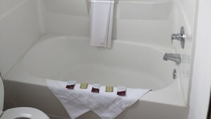 A bathroom with a bathtub, a shower, and a toilet.