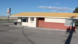A small, single-story motel with a simple, functional design.