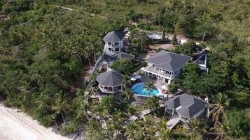 Surrounded by lush greenery and a sandy beach, this property offers stunning views and a relaxing atmosphere.