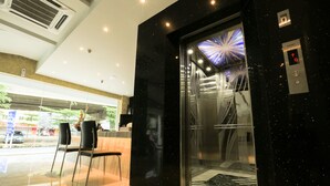 A modern elevator with a glass door and a digital display. - Mercury Boutique Hotel (Malacca City)