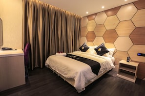 A modern hotel room with a large bed, a desk, and a control panel on the wall. - Mercury Boutique Hotel (Malacca City)