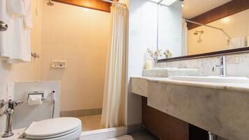 A modern bathroom with a shower, toilet, and vanity.