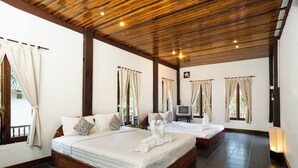 A hotel room with a large bed, a smaller bed, and a TV. - Villa Khoum Xieng Thong Boutique (Luang Prabang)
