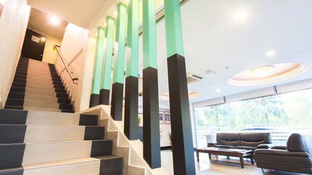 A modern interior with a staircase, a seating area, and a view of the outdoors. - Lavender Inn Nusa Bestari (Johor Bahru)