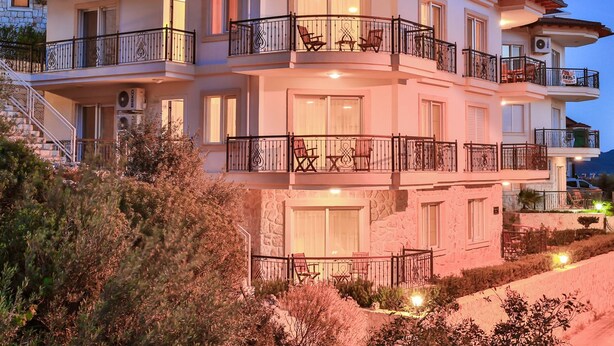 A multi-story building with balconies, staircases, and outdoor seating areas. - SC Apartments by Cinarlar (Kas)