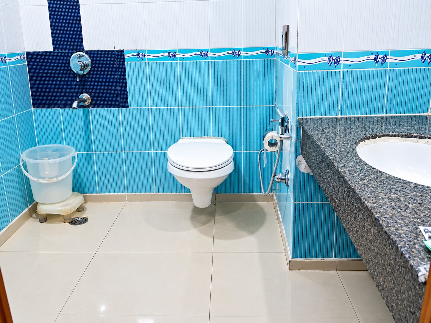 A bathroom with a toilet, a sink, and a shower.