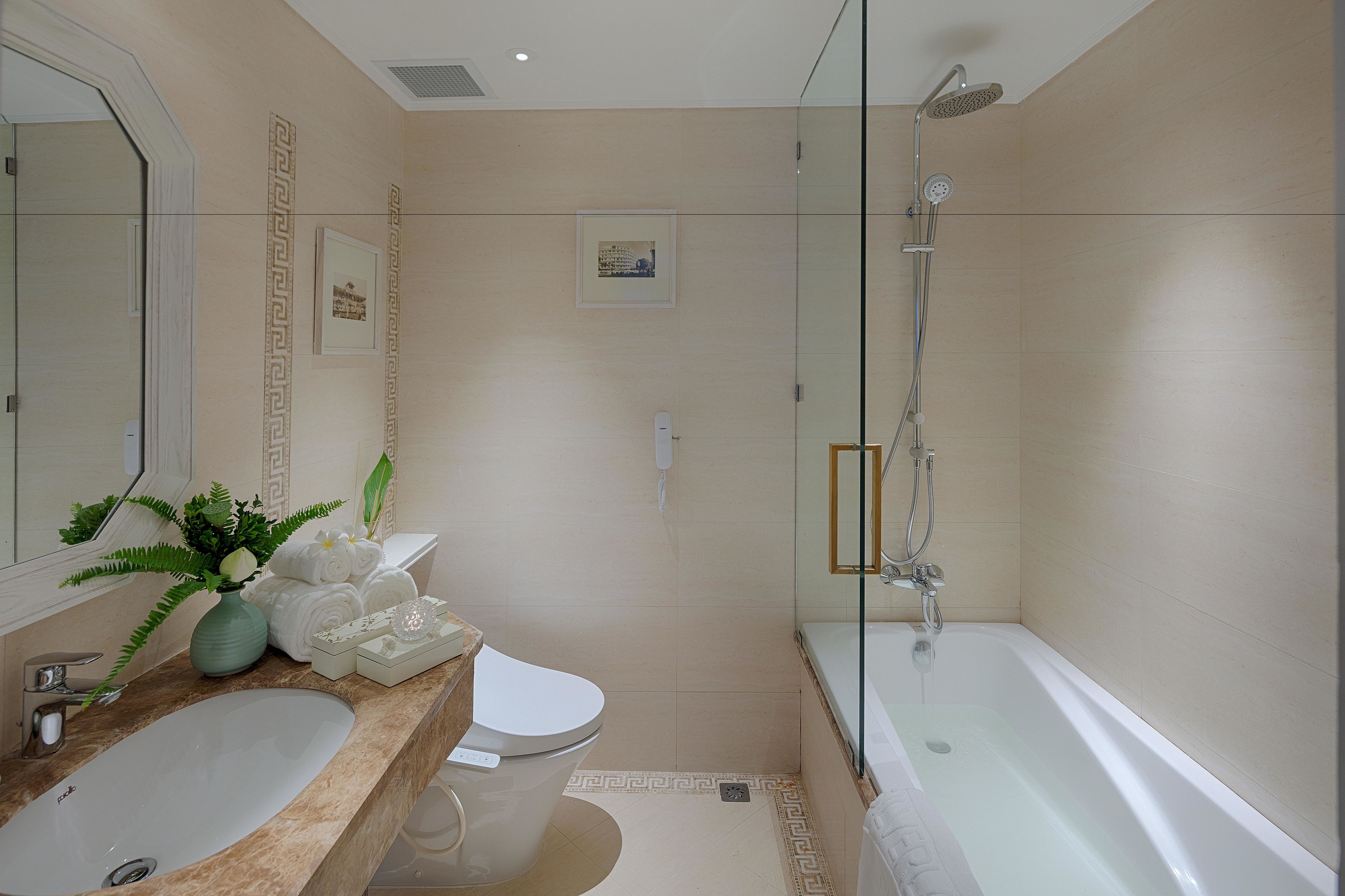 A modern bathroom with a bathtub, toilet, and sink.