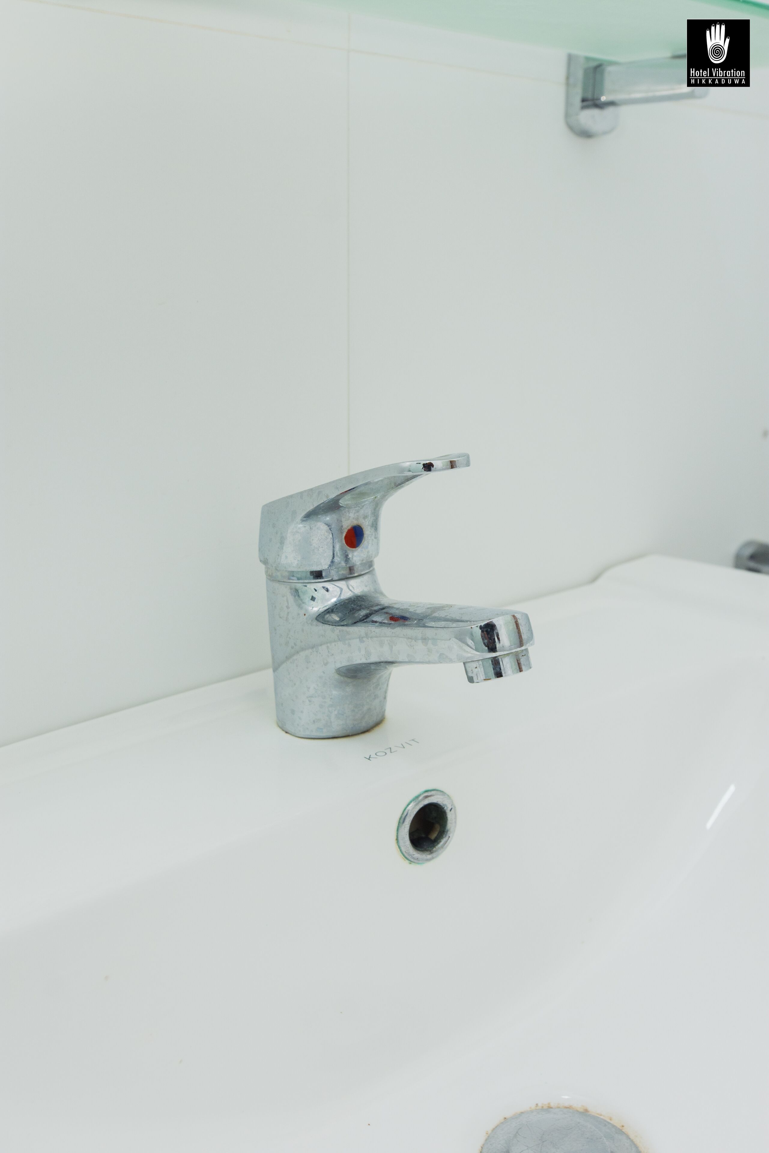 A bathroom sink with a chrome faucet and a single drain.