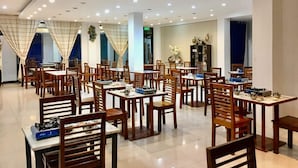 A spacious restaurant with multiple tables and chairs, recessed ceiling lights, and a modern interior design. - Discover Boracay Hotel and Spa (Kalibo)