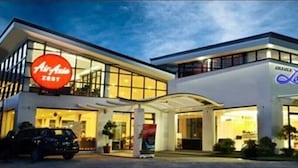 A hotel with a prominent AirAsia sign and a lounge area. - Discover Boracay Hotel and Spa (Kalibo)