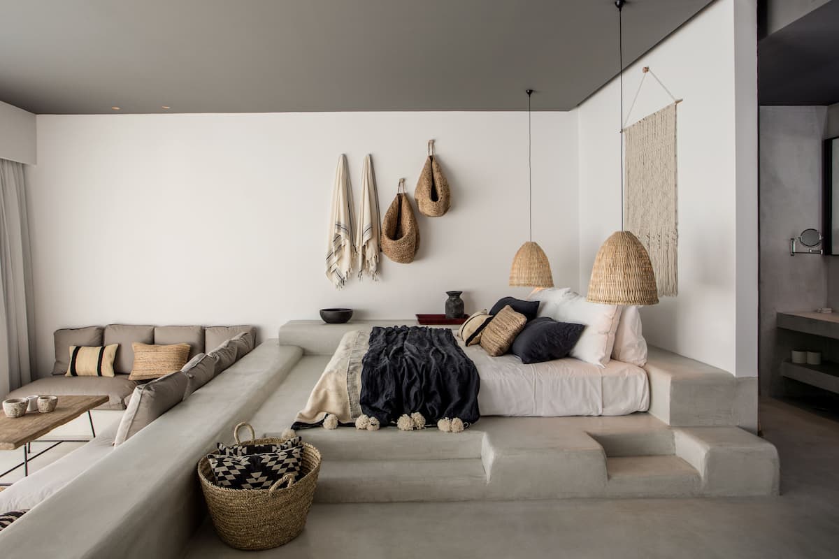 A modern living room with a sofa, a coffee table, and a staircase.