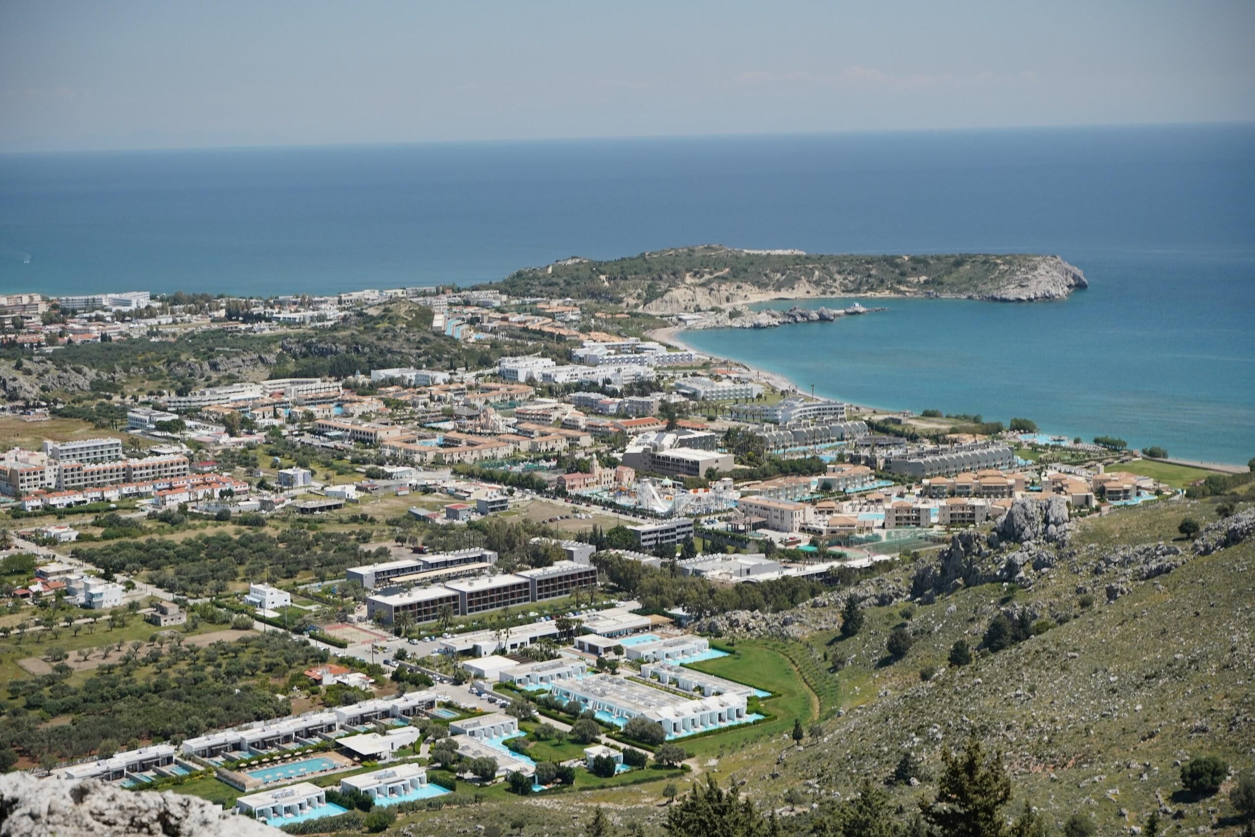 Ein Küstenresort mit mehreren Gebäuden, einem Strand und Blick aufs Meer.