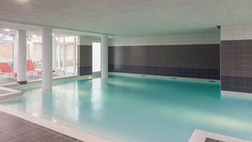 Indoor pool, open 9:00 AM to 7:00 PM, pool loungers