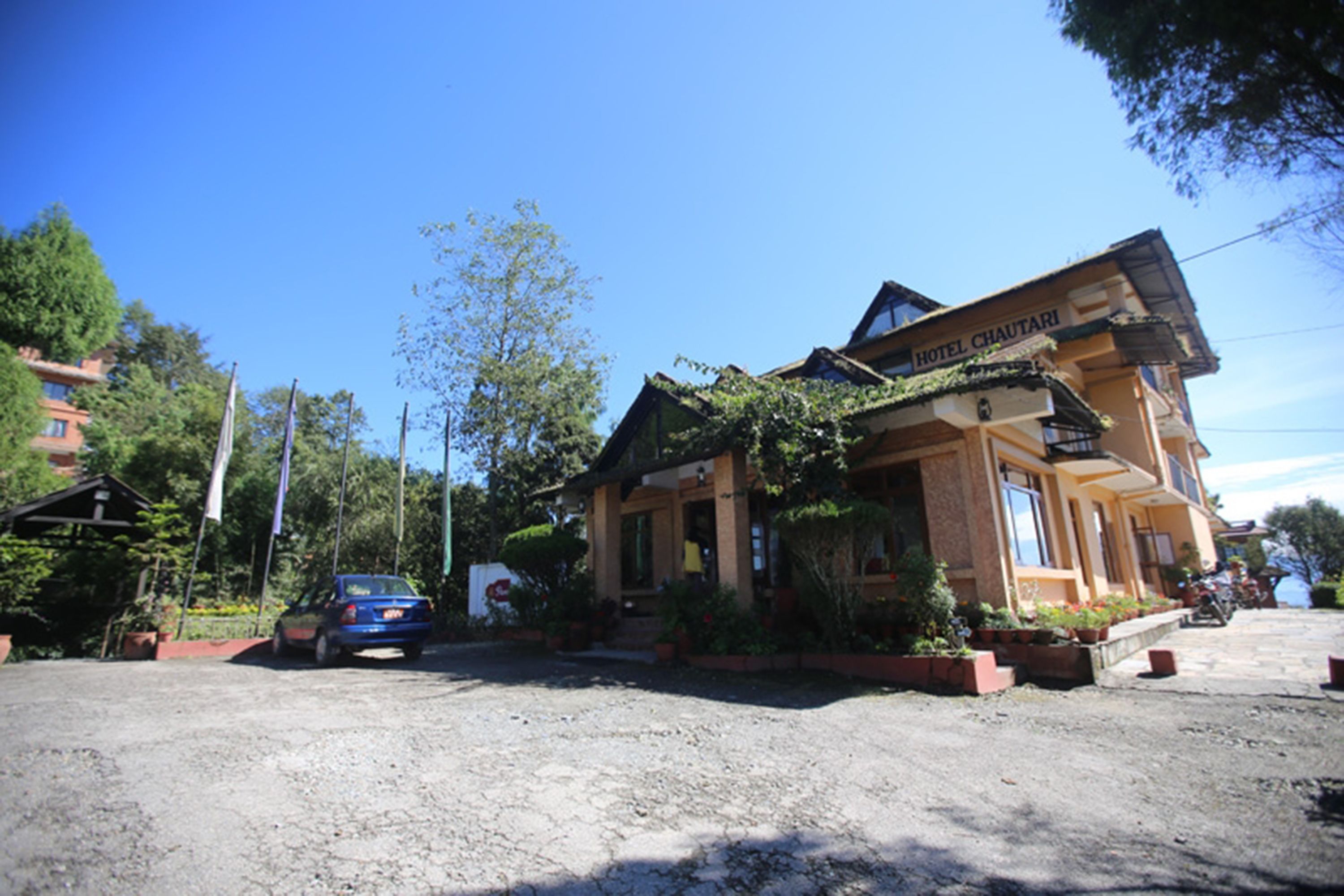 A two-story building with a sign reading "Hotel Chaudari".