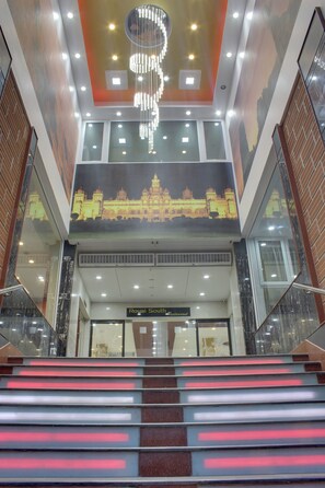 A staircase with illuminated steps leading to a restaurant named "Royal South Restaurant". - SRT Alpines (Anekal)