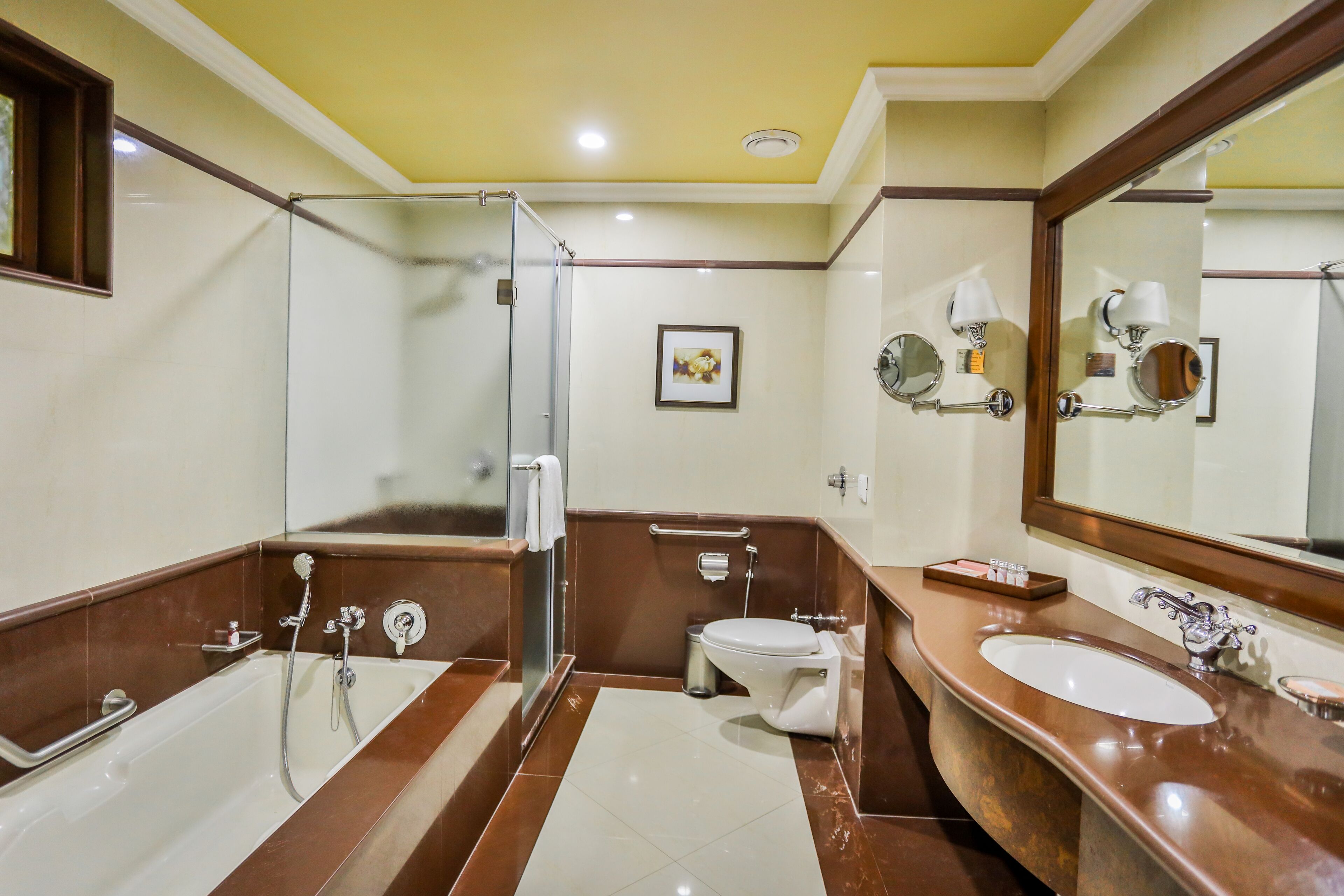 A bathroom with a bathtub, shower, toilet, and sink.