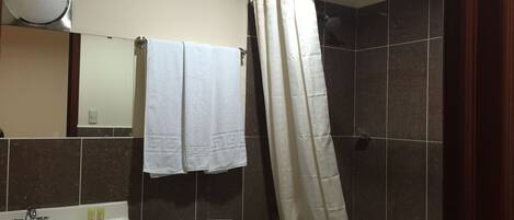 A bathroom with a sink, toilet, and bathtub.