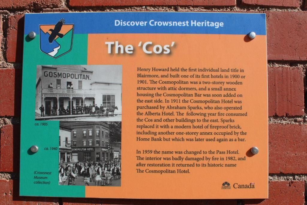 Una placa histórica que detalla la historia del hotel 'Cos', incluyendo su nombre original, modificaciones arquitectónicas y restauración.