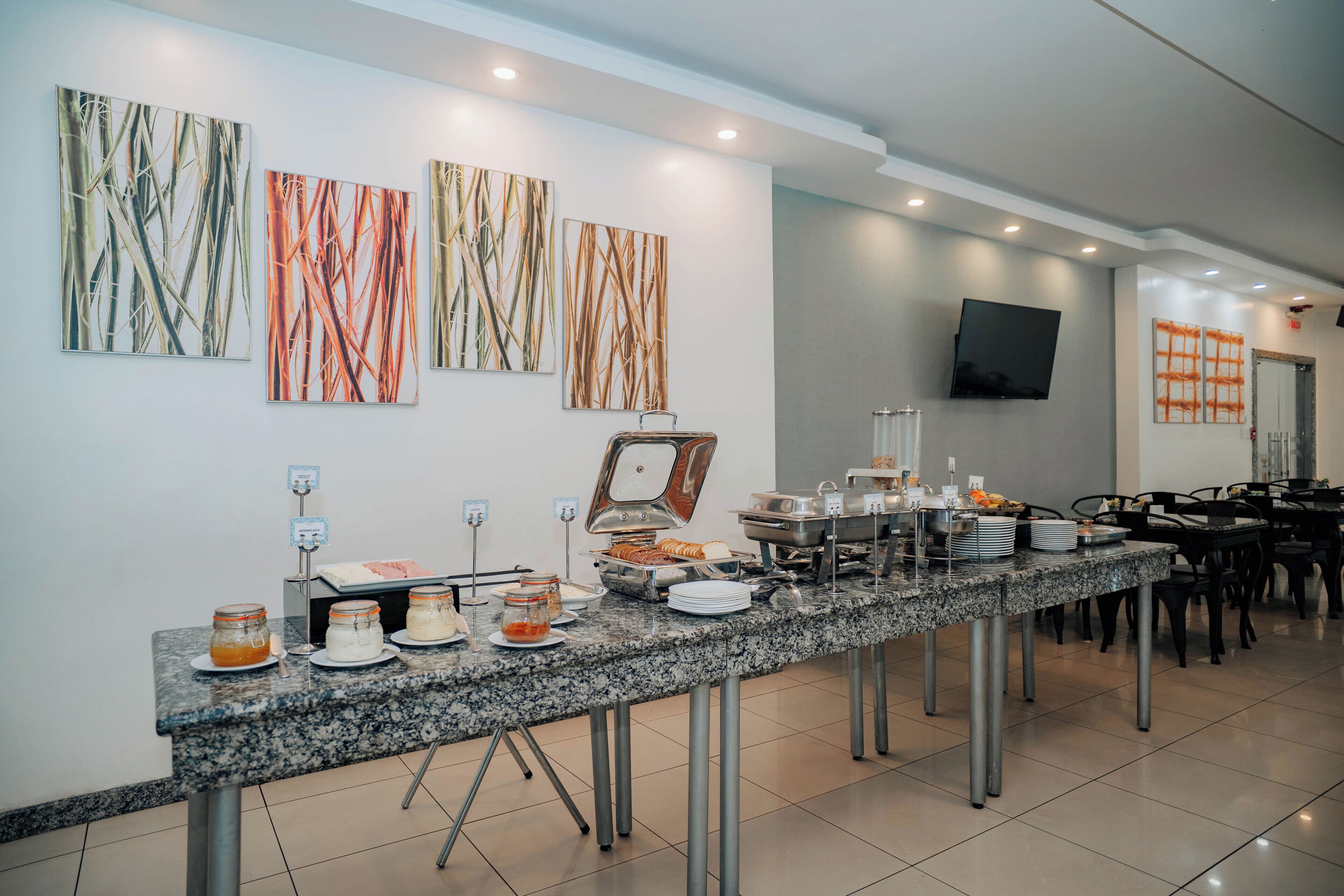 Un buffet proposant une variété de plats et un téléviseur fixé au mur.