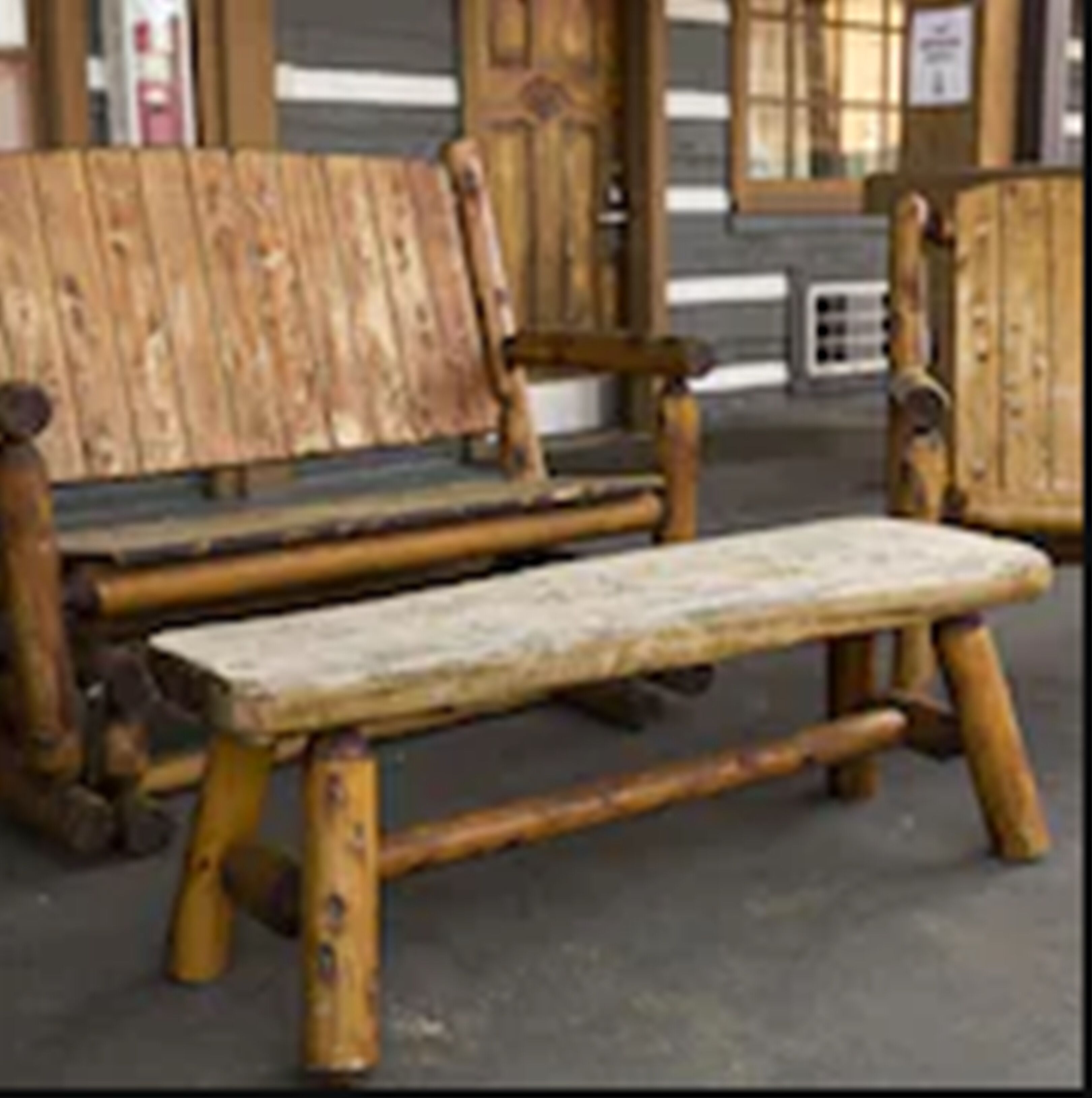 A wooden bench with a slatted seat and backrest, positioned outdoors.