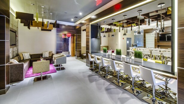 A modern interior with a seating area, a bar, and a kitchen. - The Brooklyn (Brooklyn)