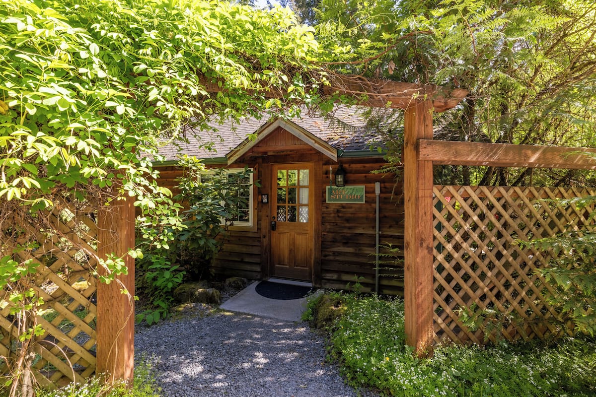 A wooden cabin with a wooden door, a small porch, and a sign indicating it is a lodge.