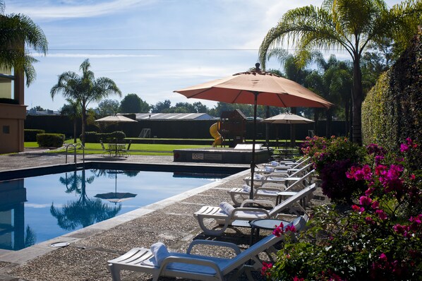 Outdoor pool, open 7:00 AM to 7:00 PM, pool umbrellas