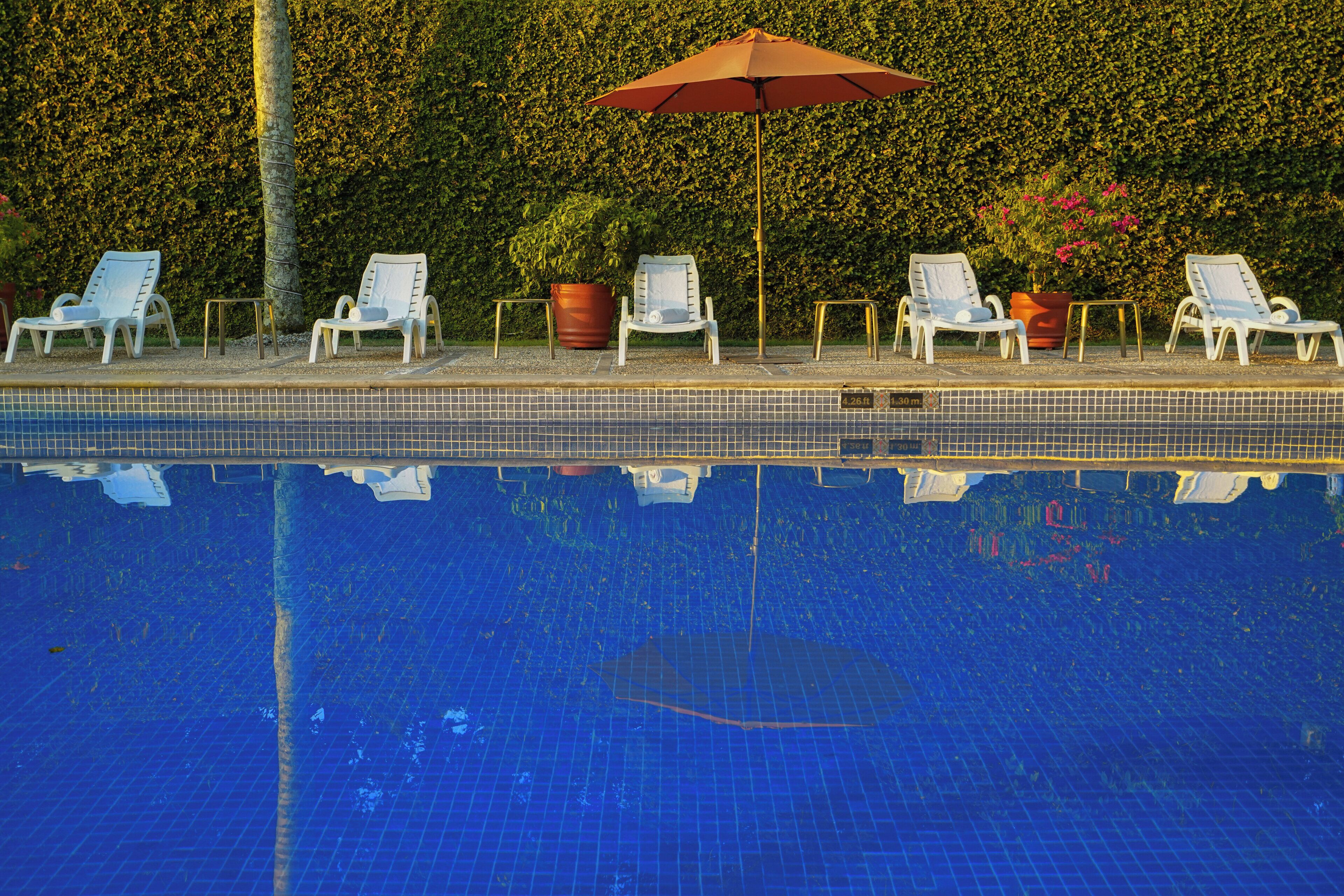 outdoor pool, open 7:00 am to 7:00 pm, pool umbrellas