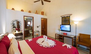A hotel room with a bed, a desk, a television, and a ceiling fan. - Ha An Hotel (Hoi An)