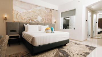 A modern hotel room with a large bed, a nightstand, a wall-mounted lamp, and a large window.
