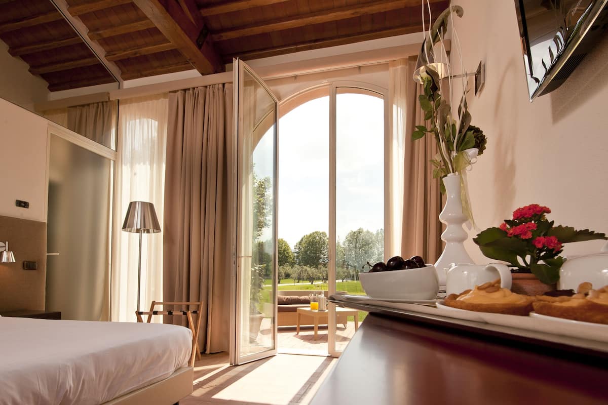 junior triple room, private bathroom, garden view | premium bedding, in-room safe, desk, laptop workspace