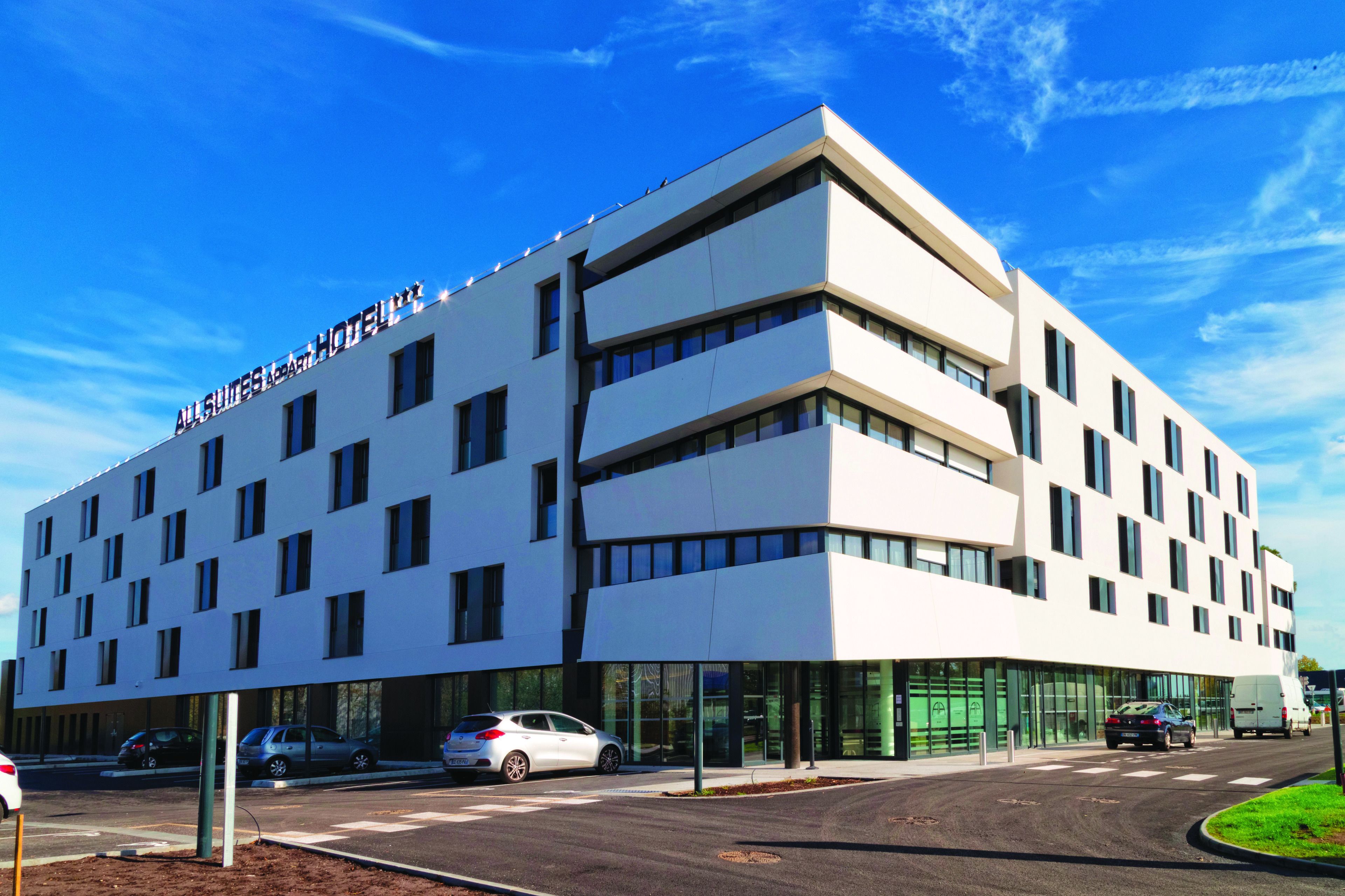 A modern hotel with a flat facade and multiple windows.