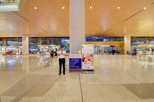 A spacious indoor area with a polished floor, wooden ceiling, and glass walls.