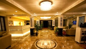 A hotel lobby with a marble floor, a reception desk, and several seating areas. - Venus Suite Hotel (Denizli)
