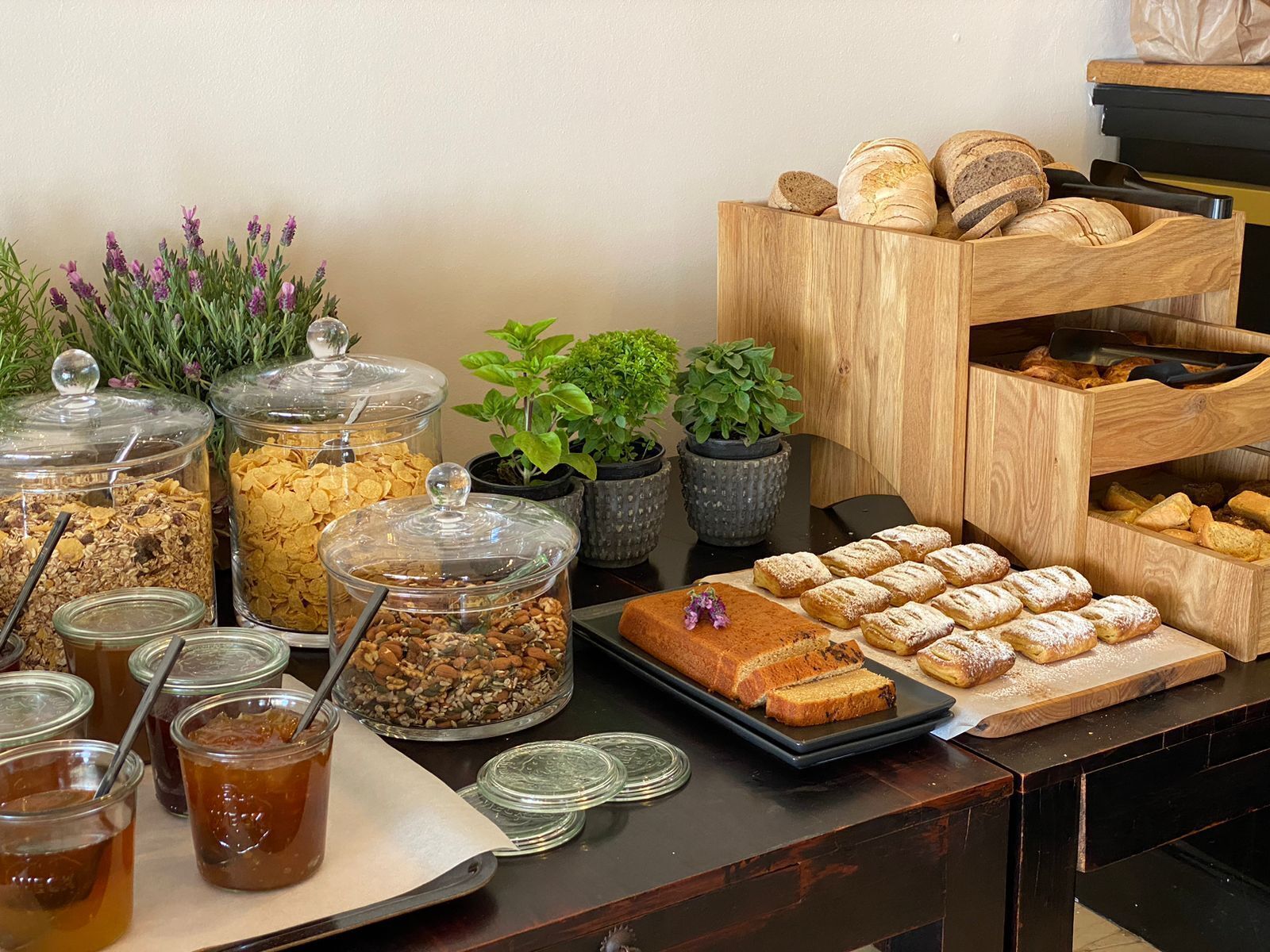 A buffet with various food items, including cereals, pastries, and beverages.