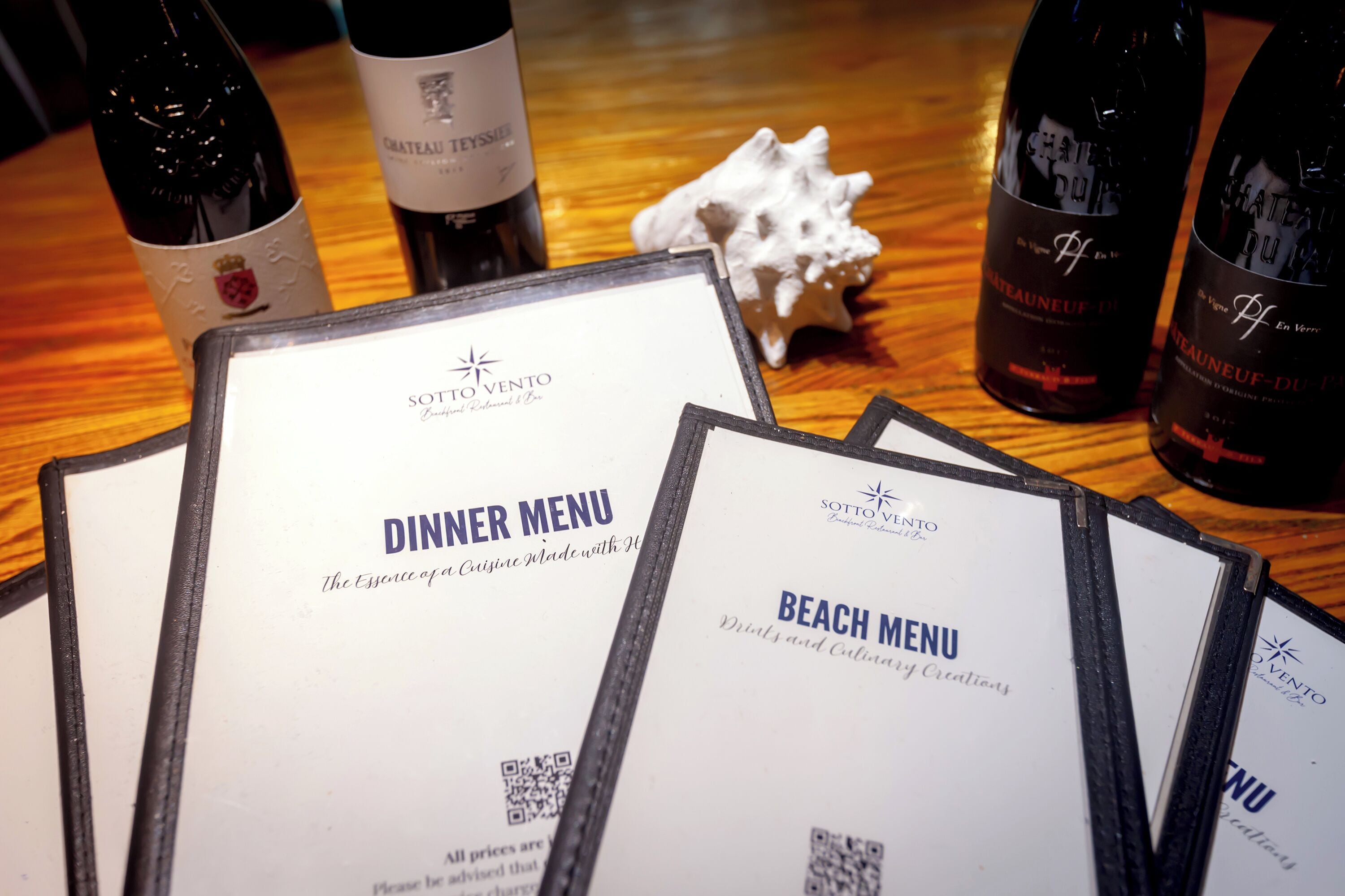 A table with wine bottles and menus.