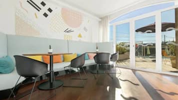 A modern interior with a sofa, chairs, and a table.