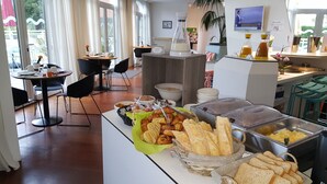 A breakfast buffet with various food items and a coffee station. - Adonis Mougins (Mougins)