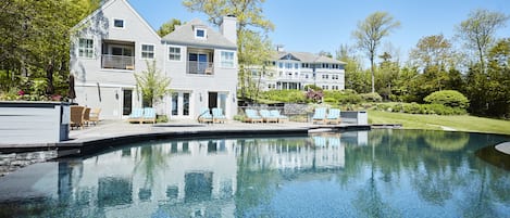 Una piscina al aire libre, tumbonas