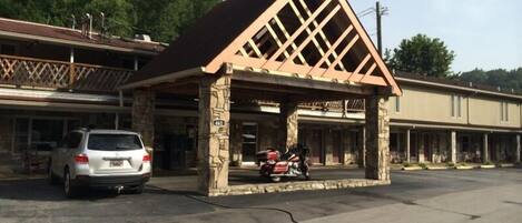 A building with a stone facade and a triangular roof structure.