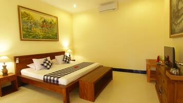 A neatly arranged bedroom with a wooden bed, a bench, a nightstand, and a dresser.