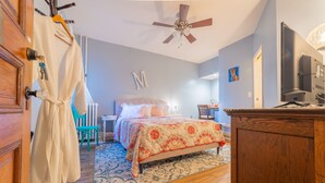 A bedroom with a bed, a desk, a chair, a wardrobe, and a ceiling fan. - The Maid's Quarters Bed Breakfast & Tearoom (Pottsville)