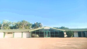 A building with a green roof and large glass windows. - HomeTown Inn By OYO Lakin, KS (Lakin)