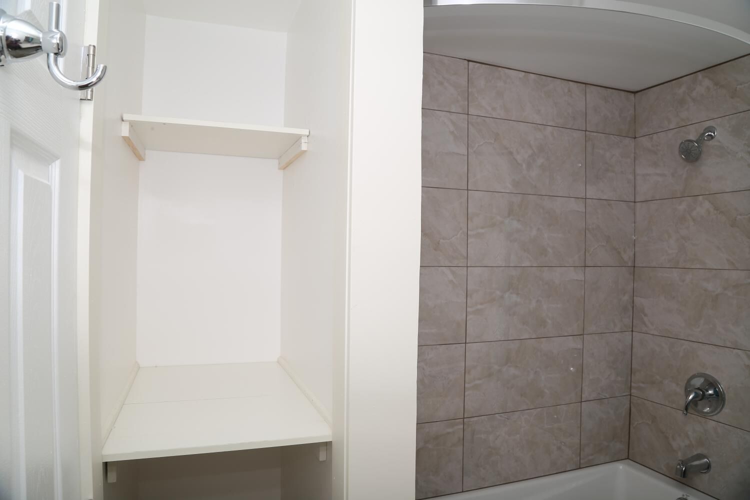 A bathroom with a shower area, a toilet, and a sink.