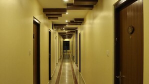 A long, narrow hotel corridor with doors on both sides and a central walkway. - Mahadev Hotel (Kathmandu)