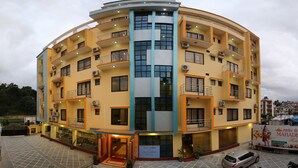 A multi-story hotel with a curved facade, balconies, and air conditioning units. - Mahadev Hotel (Kathmandu)